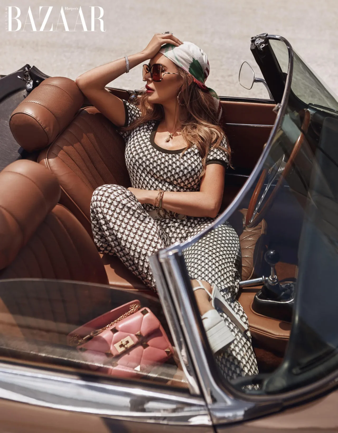 Model relaxing in a vintage convertible