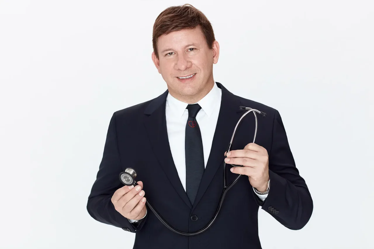 Doctor in a navy suit holding a stethoscope